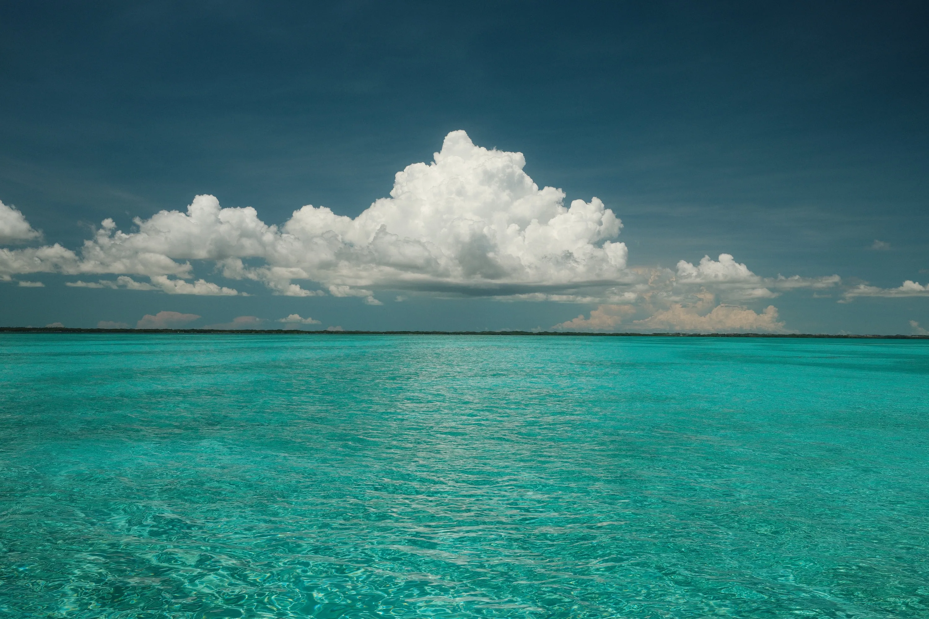 Blue Water — A single cloud stacked over the shallows.