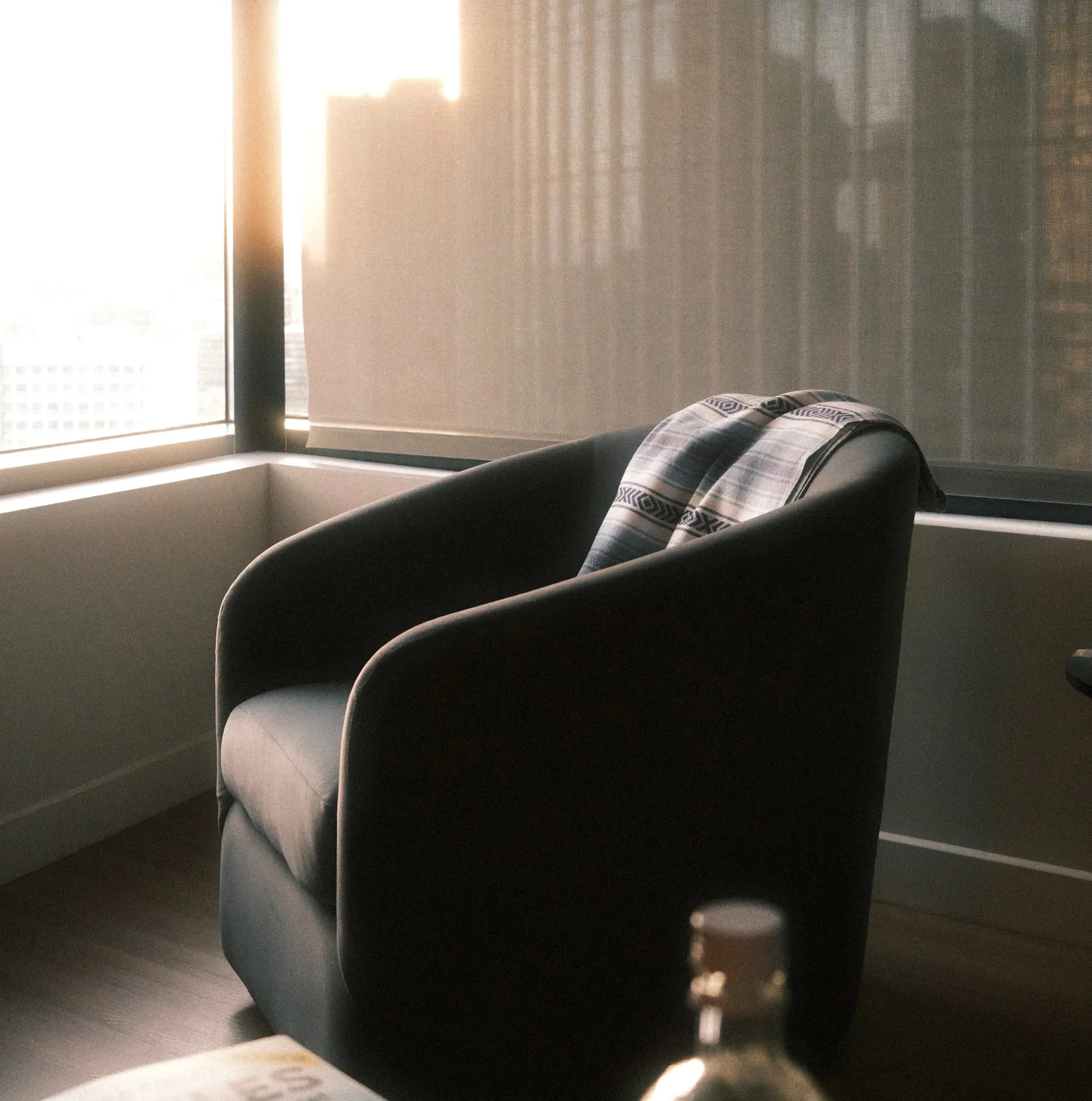 An armchair in the last of the window light.